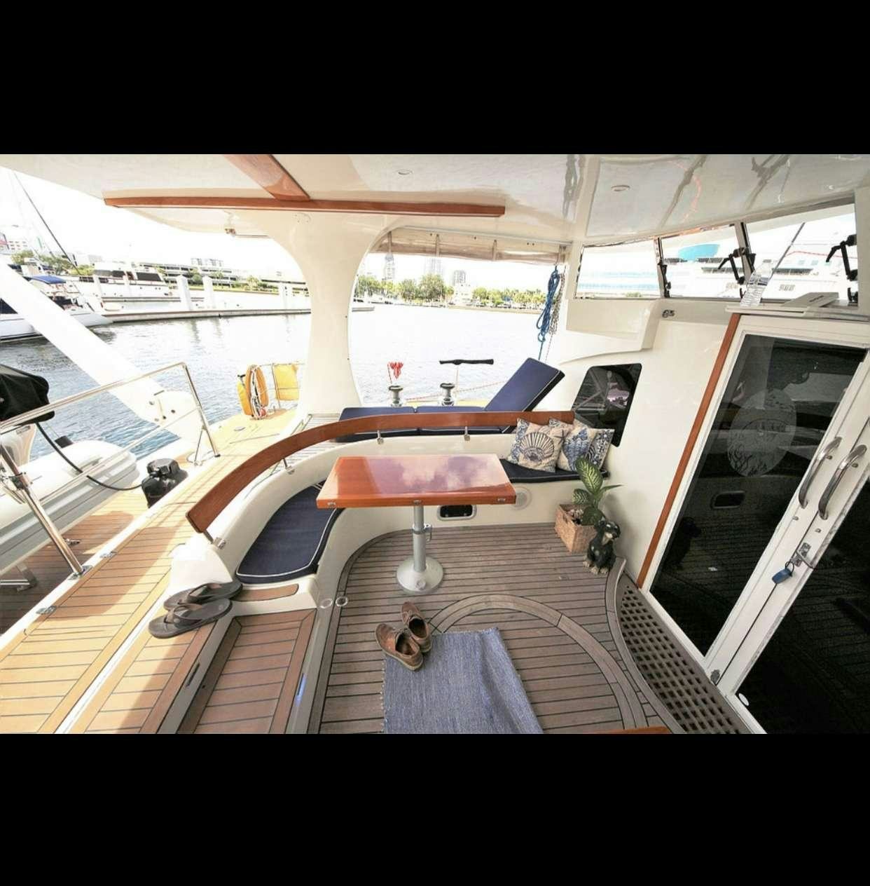 a room with a table and chairs aboard SOUTHERN PASSAGE Yacht for Charter