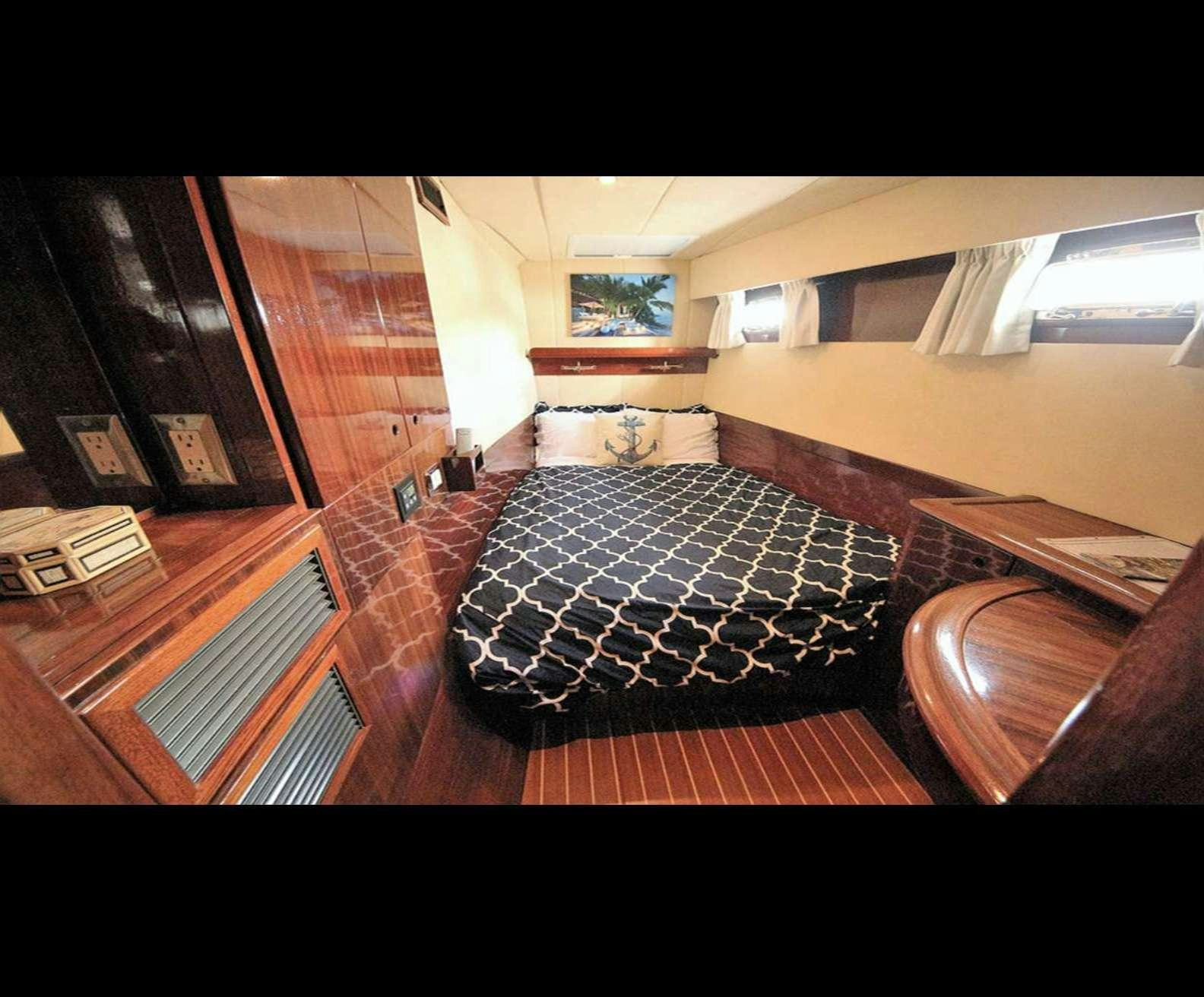 a room with a bed and a couch aboard SOUTHERN PASSAGE Yacht for Charter