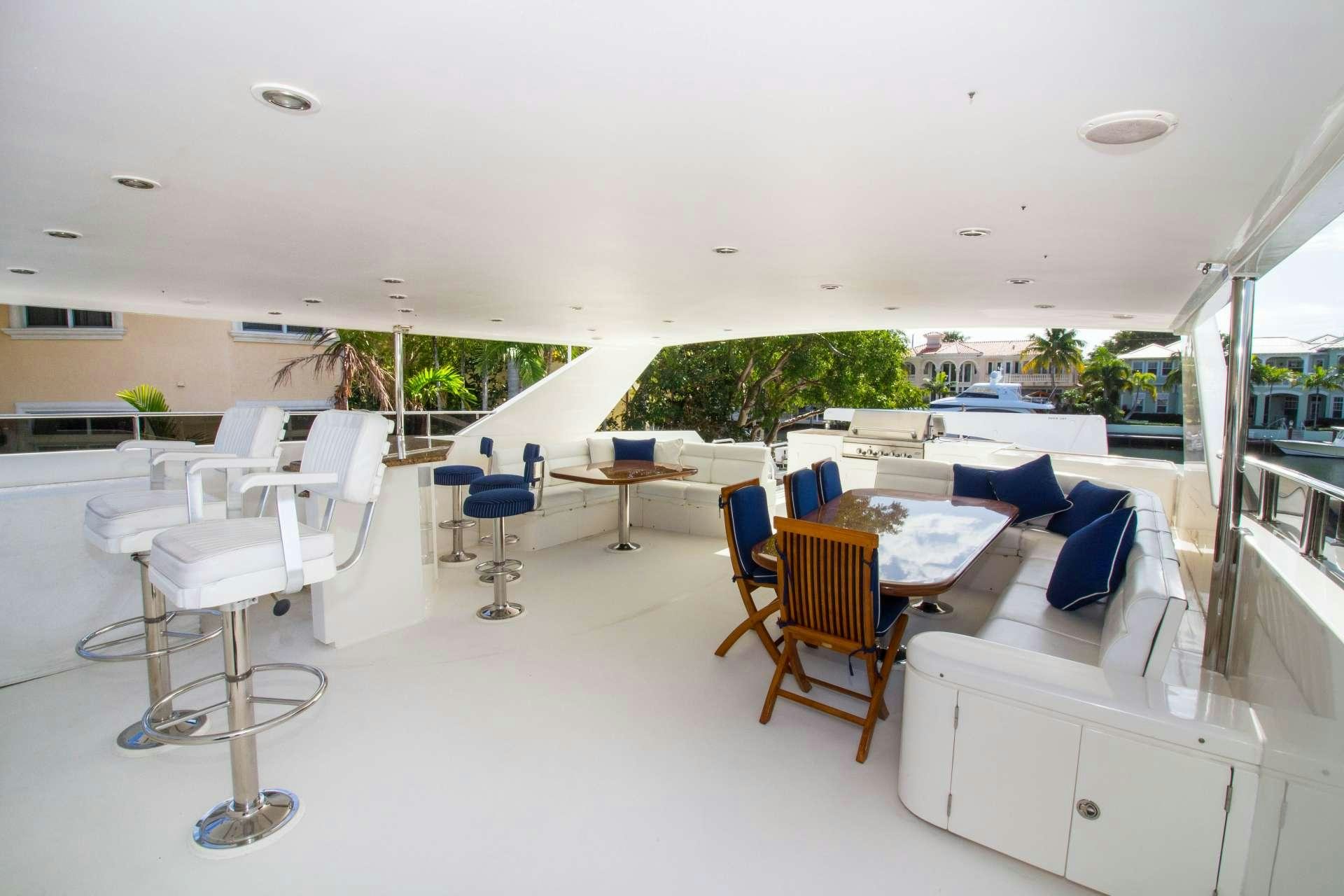 a room with tables and chairs aboard SANCTUARY Yacht for Charter