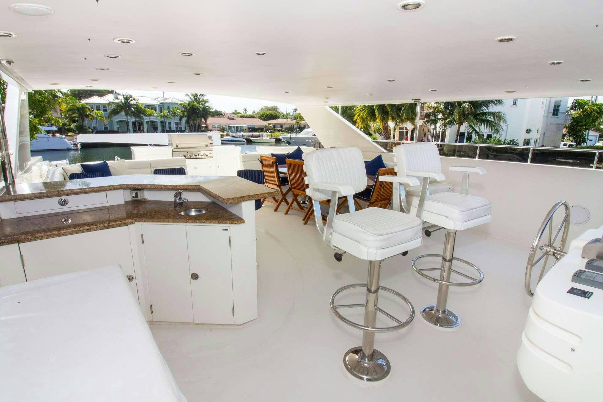 a room with tables and chairs aboard SANCTUARY Yacht for Charter