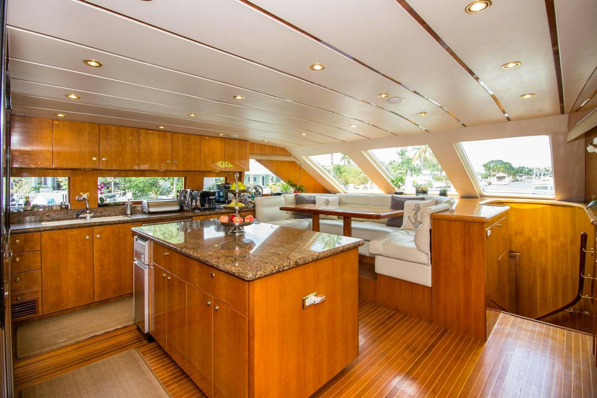 a large kitchen with wooden cabinets aboard SANCTUARY Yacht for Charter