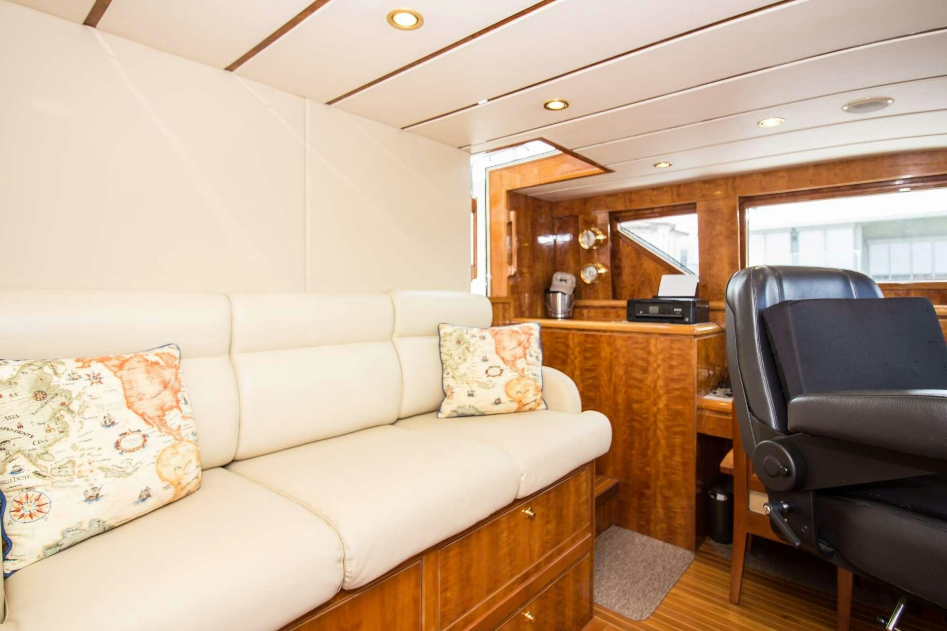 a living room with a couch and a chair aboard SANCTUARY Yacht for Charter