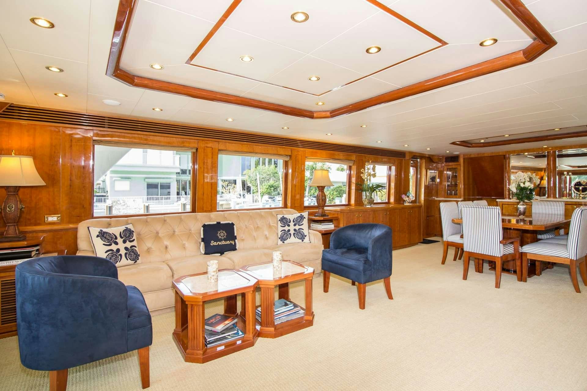 a living room with a couch and a table aboard SANCTUARY Yacht for Charter