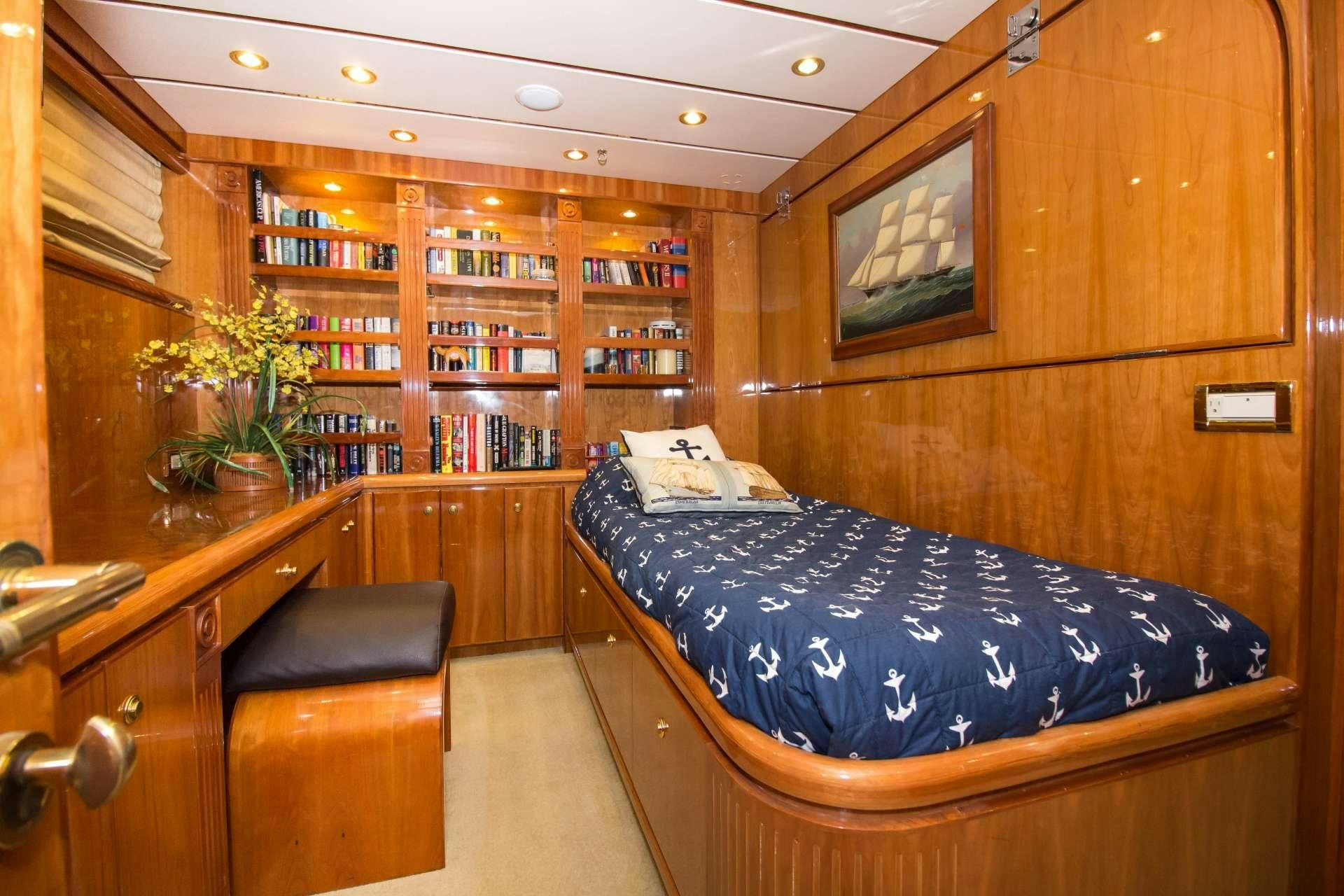 a bedroom with a blue bed aboard SANCTUARY Yacht for Charter
