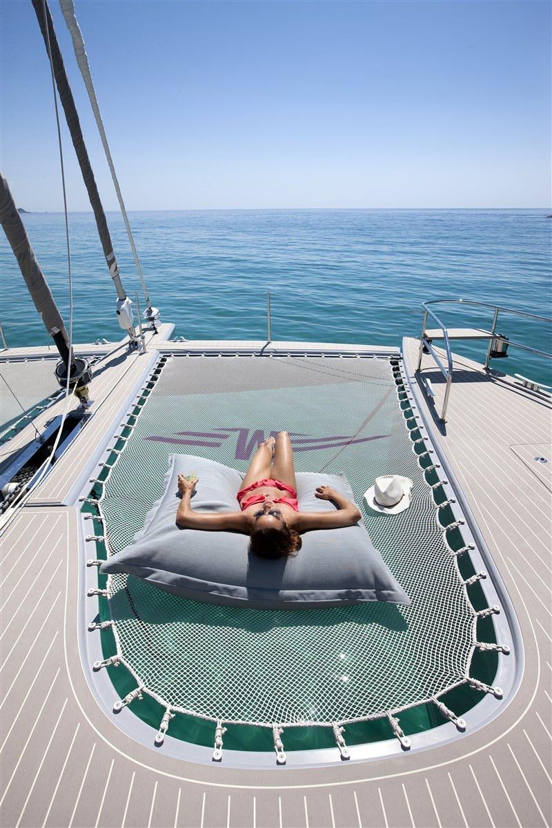 a person lying on a lounge chair on a boat aboard MAVERICK Yacht for Charter