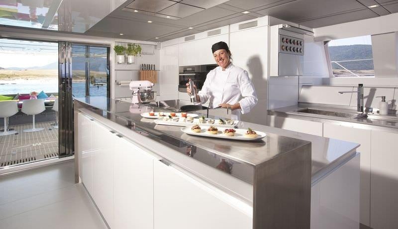 a chef in a kitchen aboard MAVERICK Yacht for Charter
