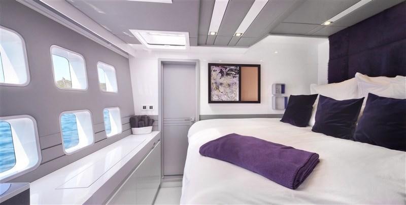 a room with a bed and a window aboard MAVERICK Yacht for Charter