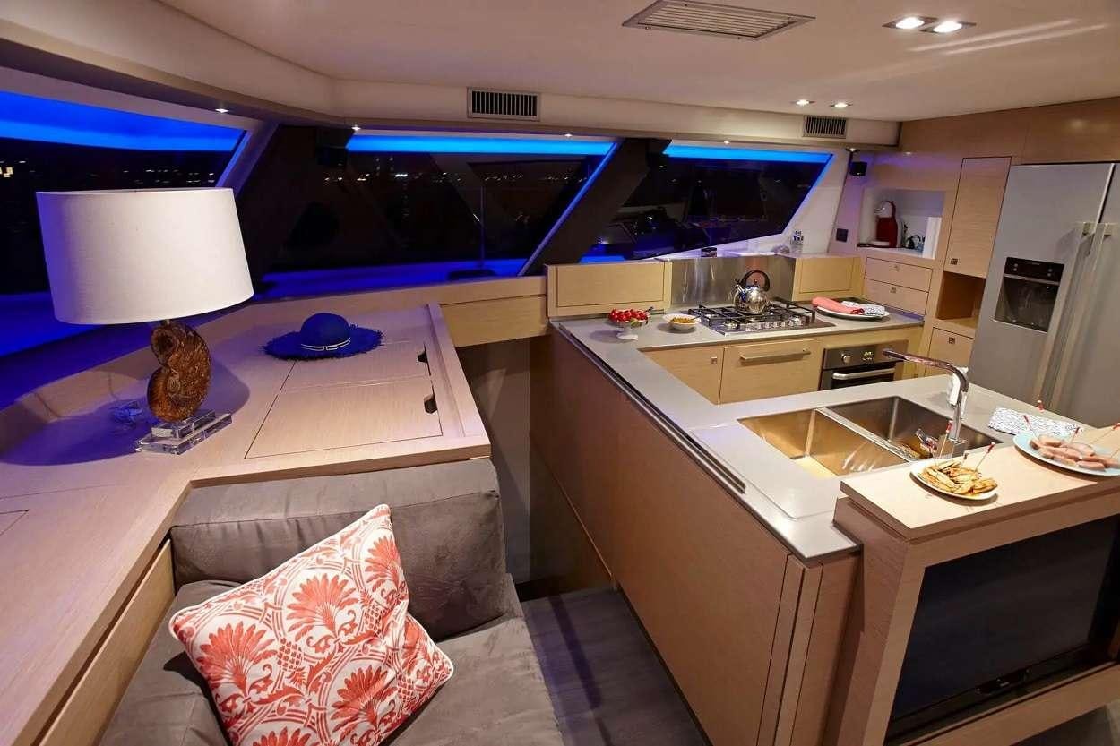 a kitchen with a couch and a tv aboard ENCHANTE Yacht for Charter