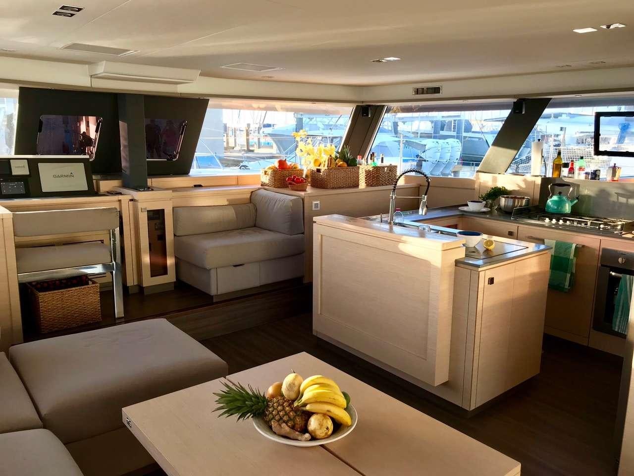 a kitchen with a table and chairs aboard ENCHANTE Yacht for Charter