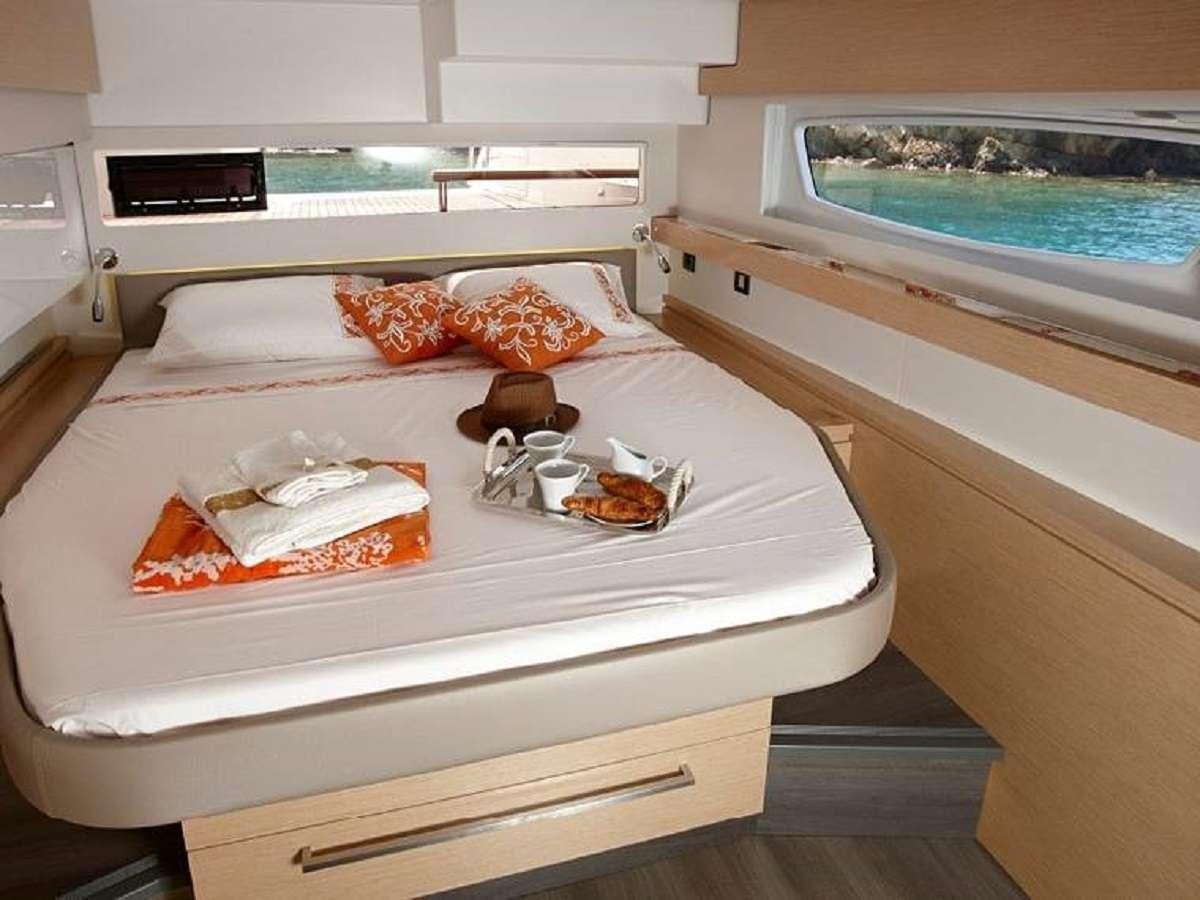 a kitchen with a sink and a bed aboard ENCHANTE Yacht for Charter