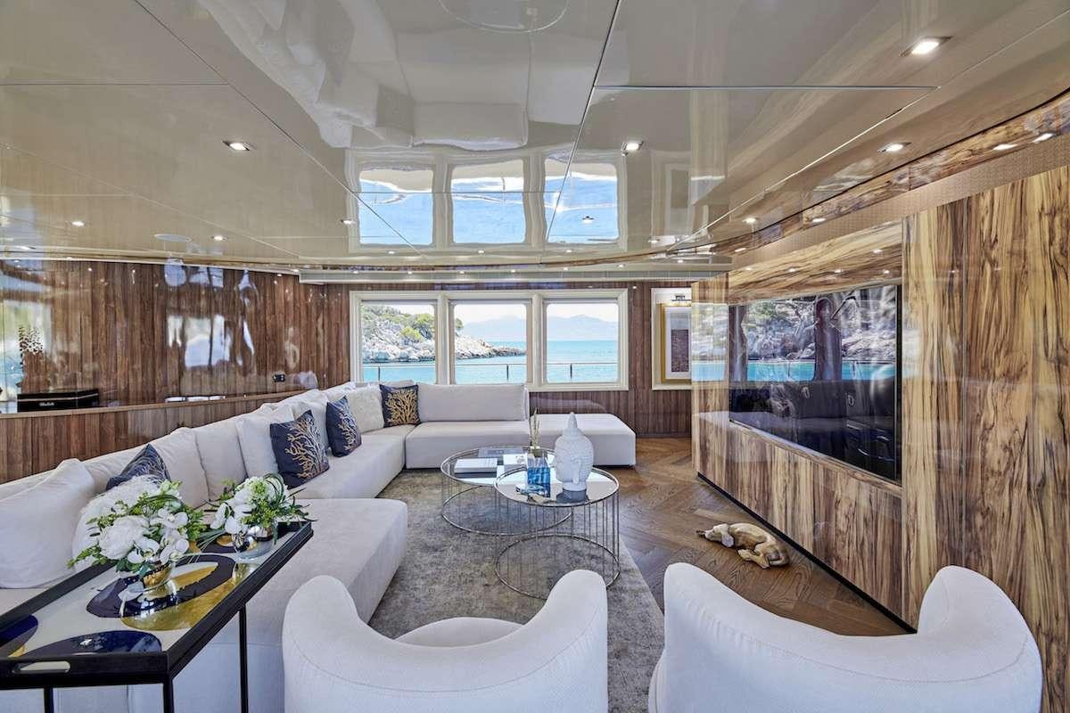 a living room with a large screen aboard DALOLI Yacht for Charter