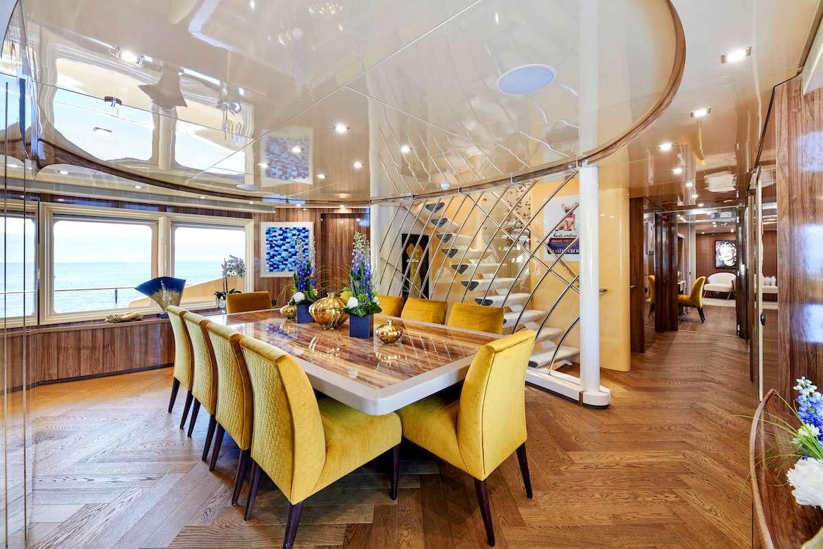 a room with a table and chairs aboard DALOLI Yacht for Charter