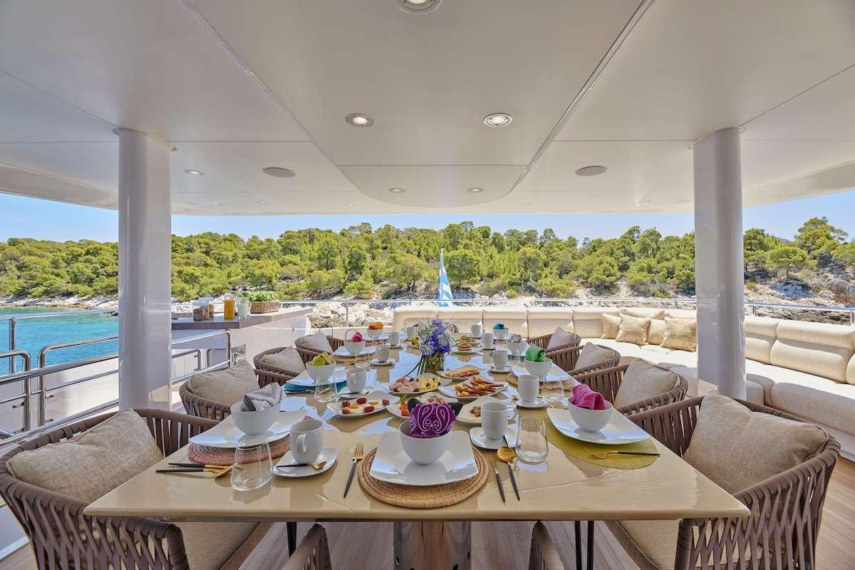 a table with plates and cups on it aboard DALOLI Yacht for Charter