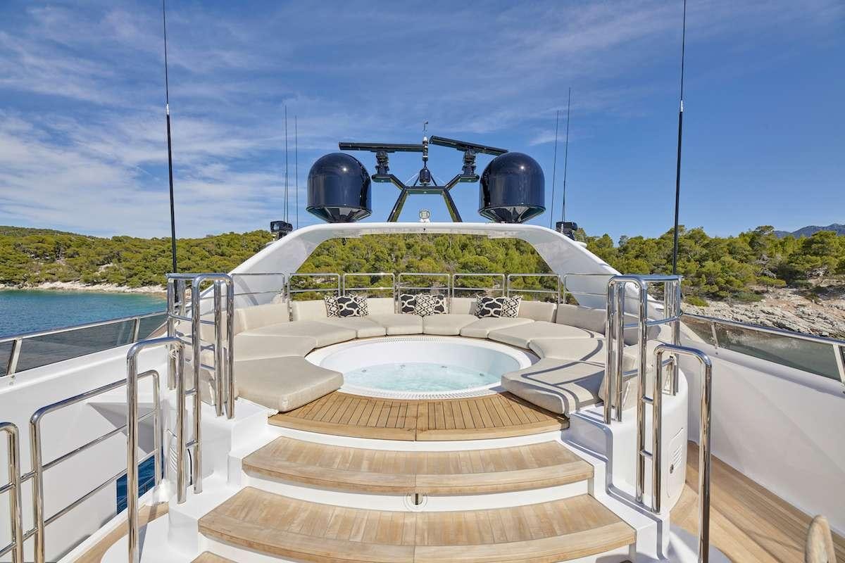 a large white boat with a large round black object on it aboard DALOLI Yacht for Charter