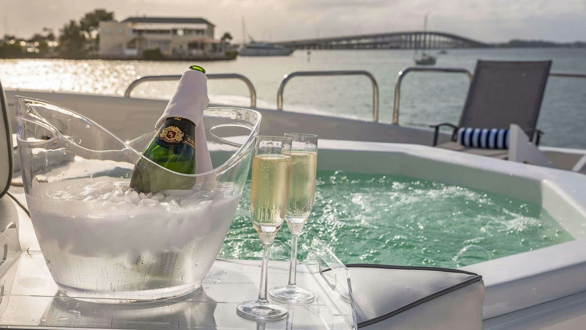 a table with wine glasses and bottles on it aboard IV TRANQUILITY Yacht for Charter