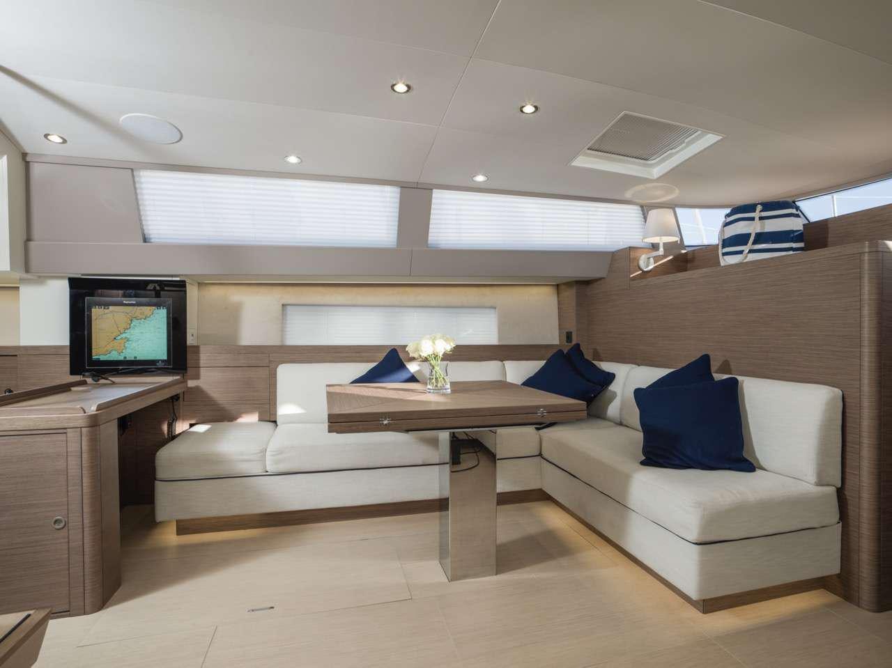 a living room with a couch and a tv aboard CNB66 Yacht for Charter