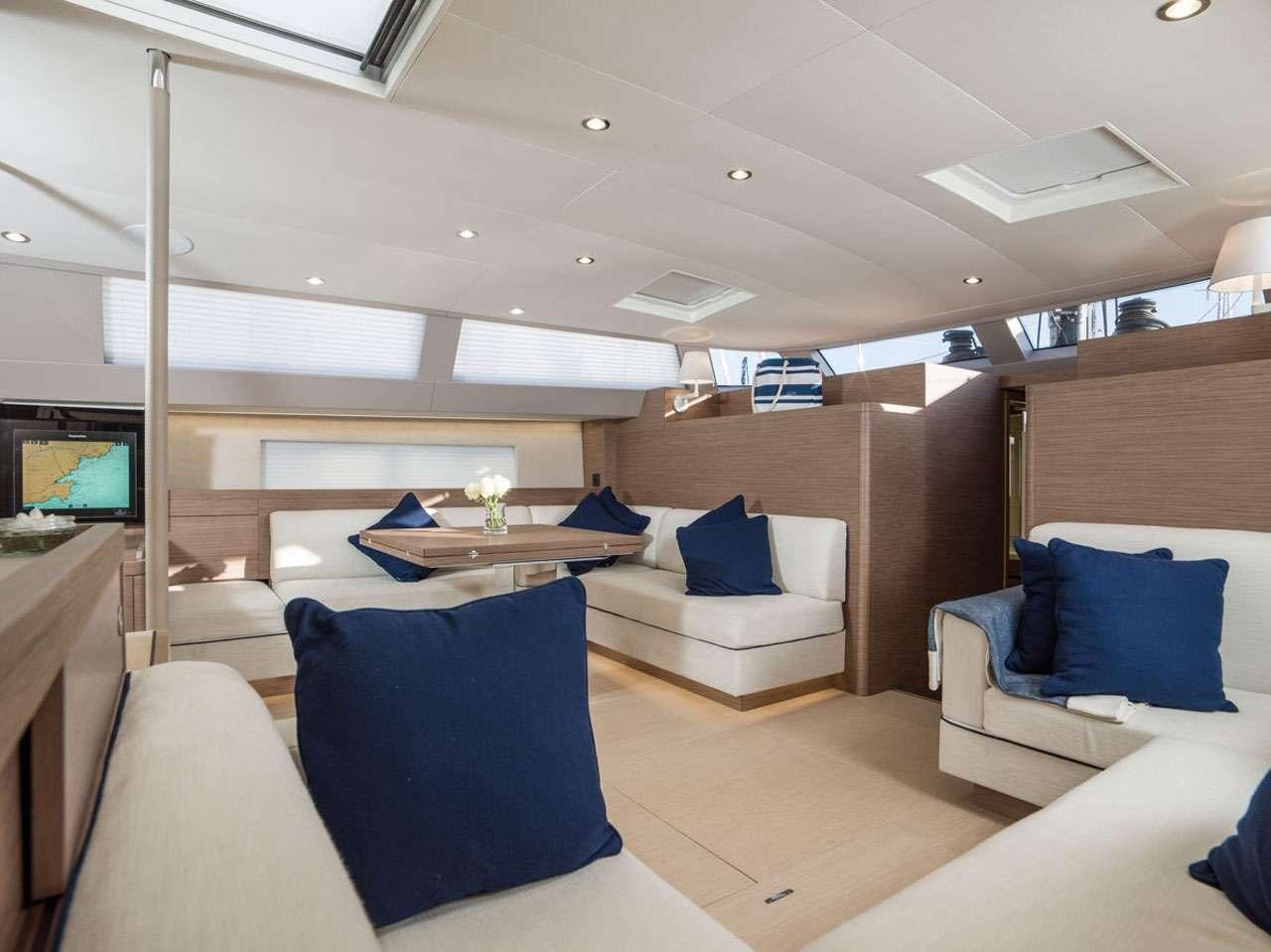 a room with a couch and a television aboard CNB66 Yacht for Charter