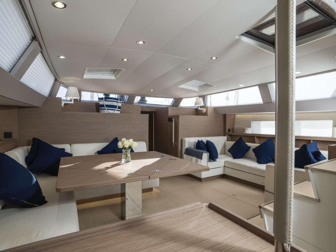 a room with a table and couches aboard CNB66 Yacht for Charter