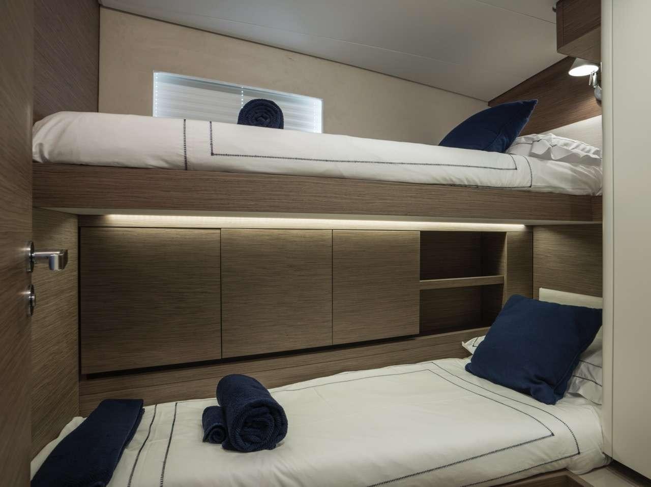 a bed with a white bed spread aboard CNB66 Yacht for Charter