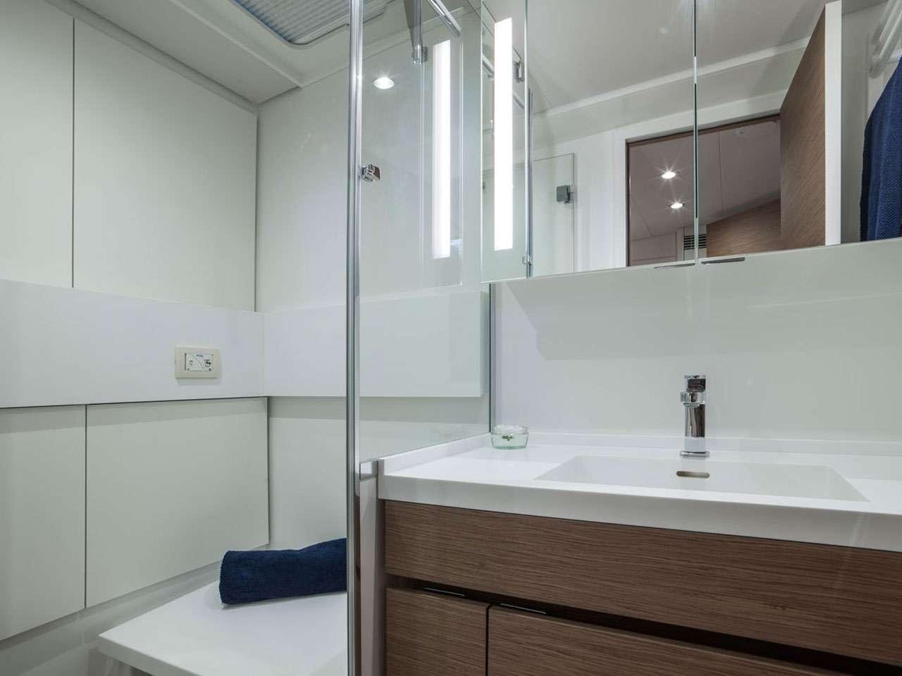 a bathroom with a glass shower aboard CNB66 Yacht for Charter