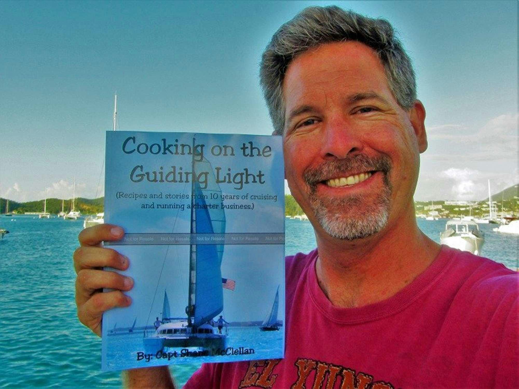 a man holding a sign aboard GUIDING LIGHT Yacht for Charter