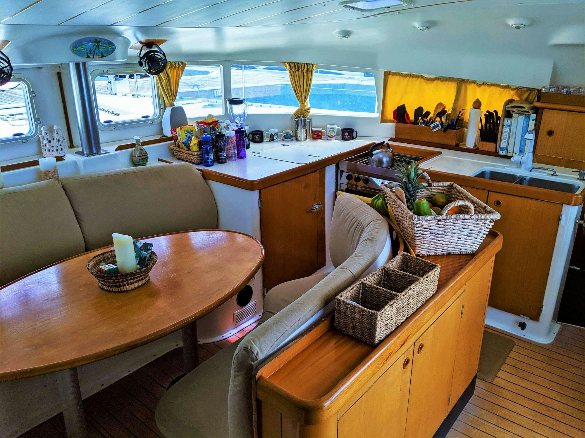 a kitchen with a table and chairs aboard GUIDING LIGHT Yacht for Charter