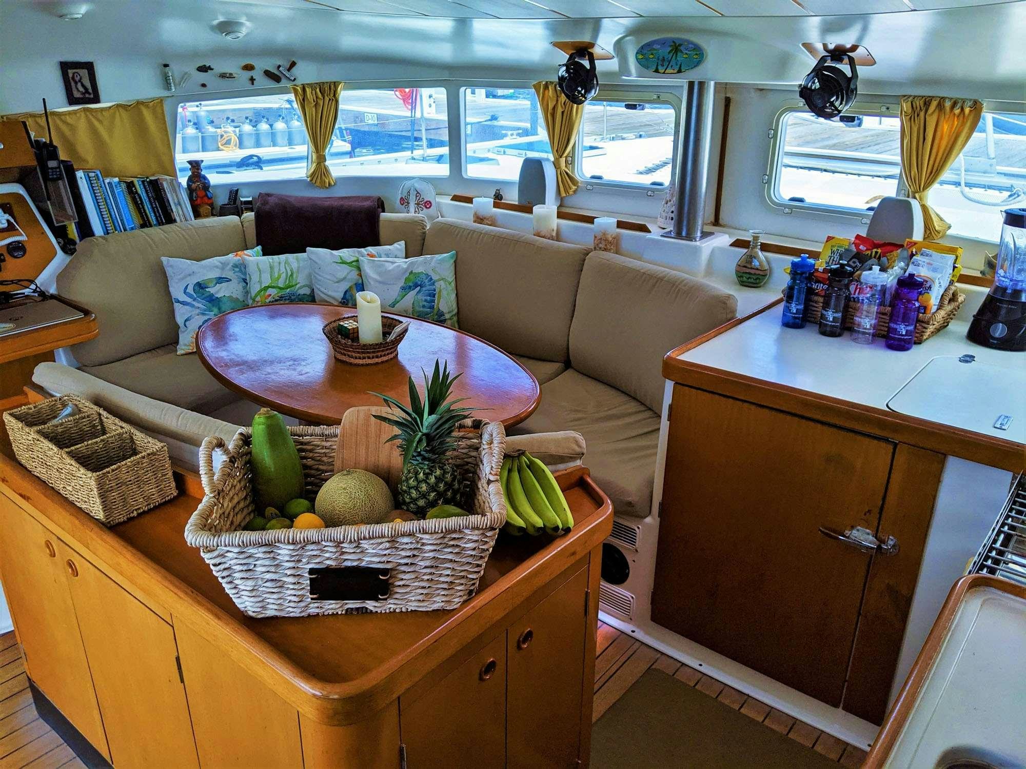 a living room with a table and couches aboard GUIDING LIGHT Yacht for Charter