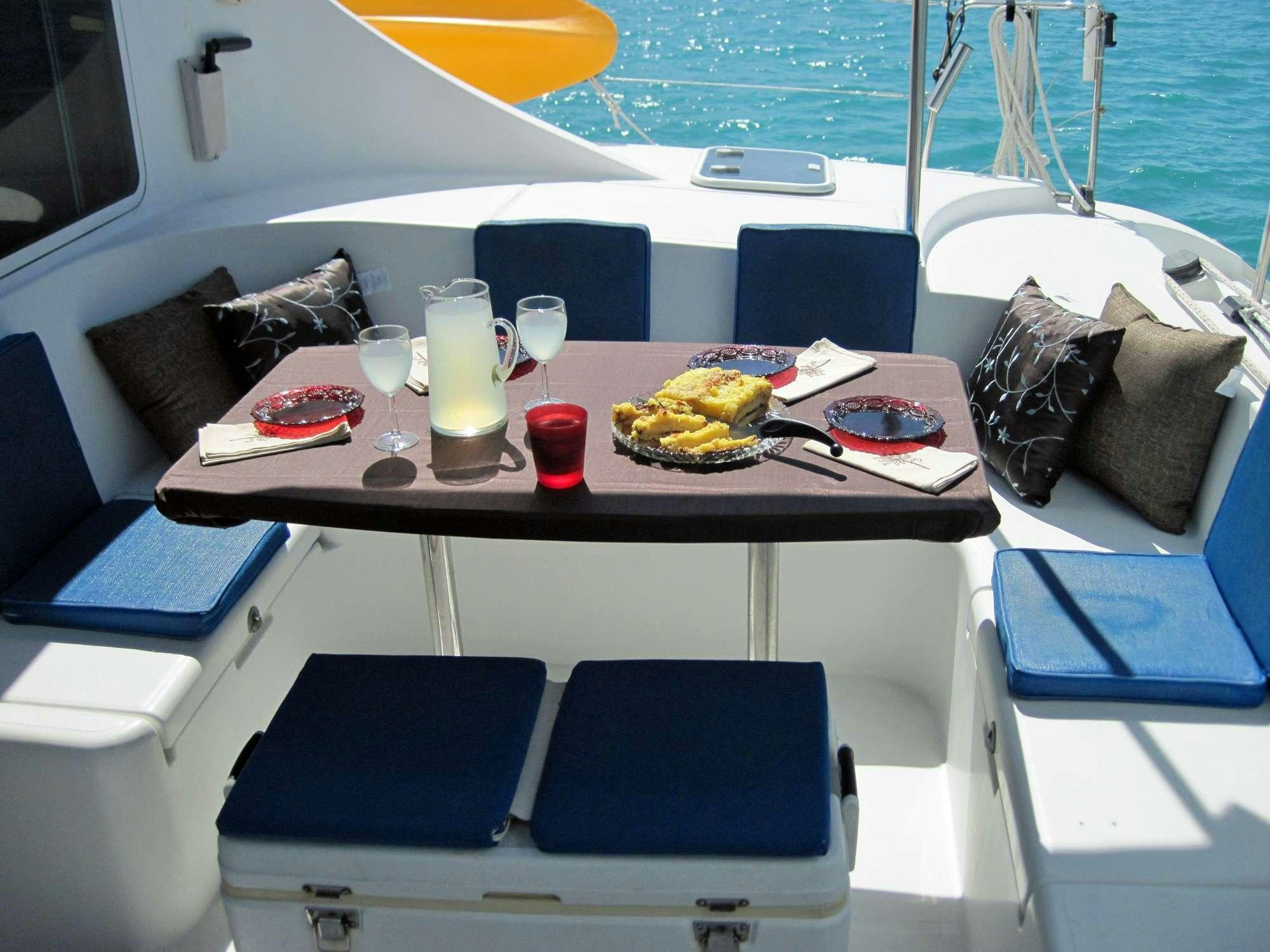 a boat with a table and chairs aboard GUIDING LIGHT Yacht for Charter