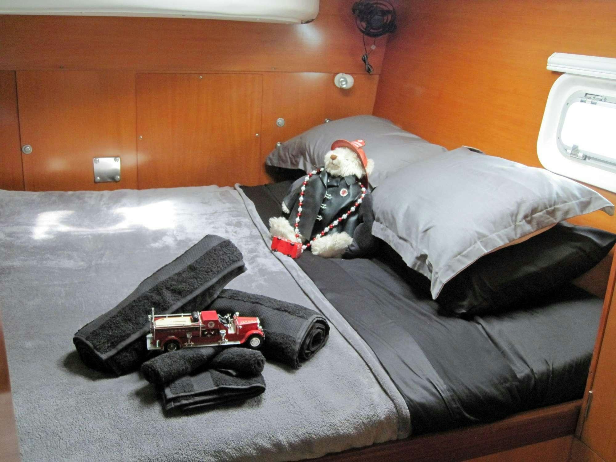 a cat lying on a bed aboard GUIDING LIGHT Yacht for Charter