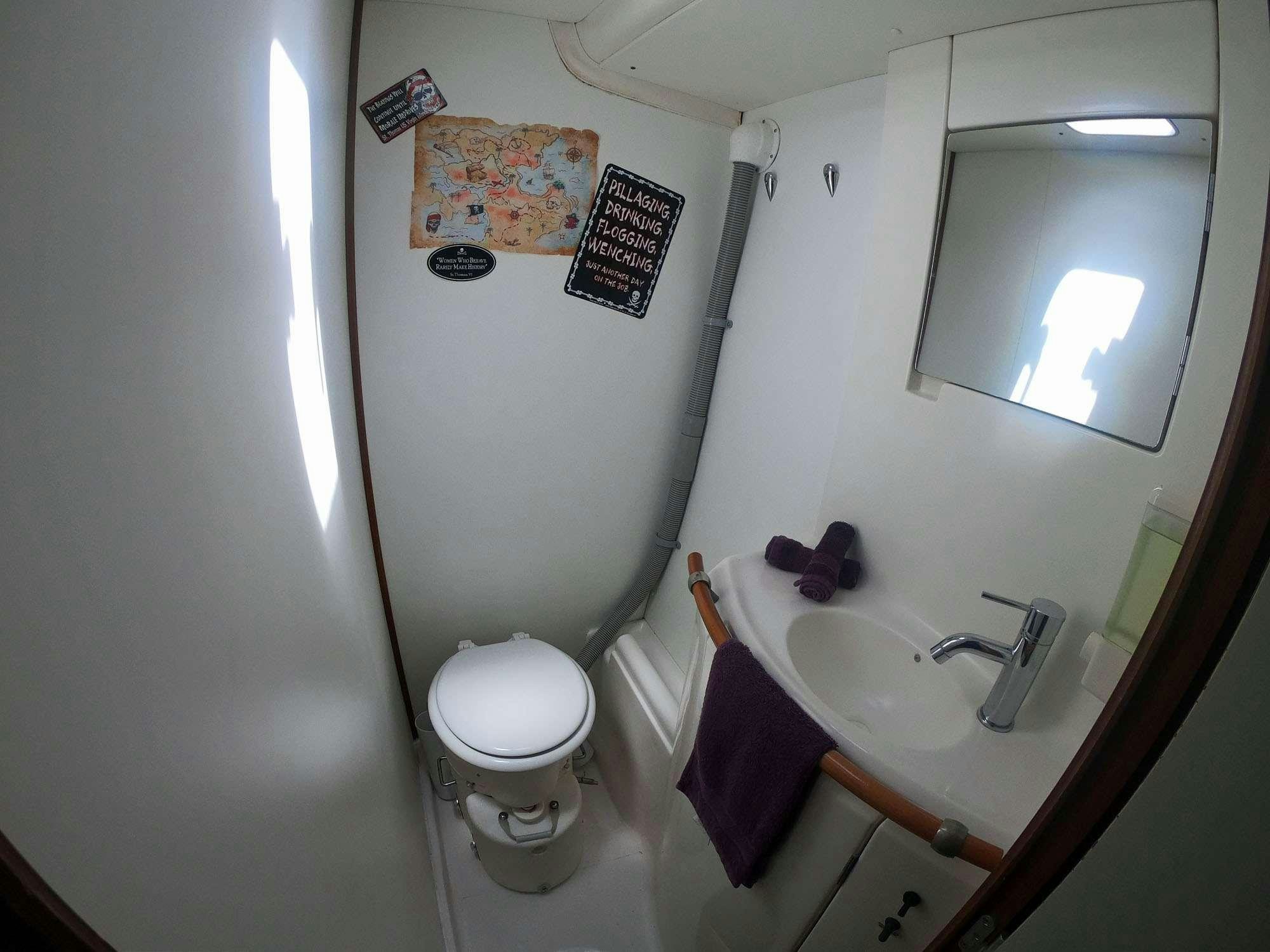 a bathroom with a toilet and a sink aboard GUIDING LIGHT Yacht for Charter