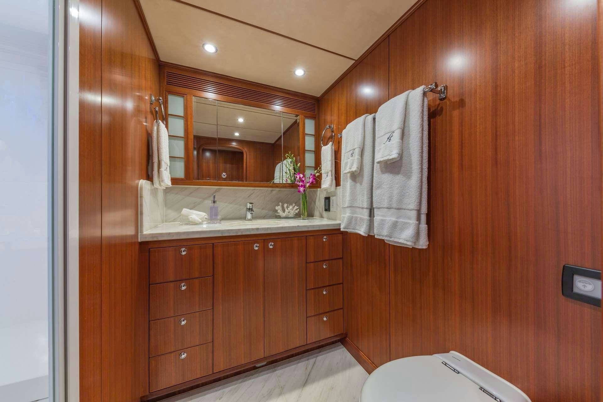 a bathroom with wooden cabinets aboard ASTURIAS Yacht for Charter