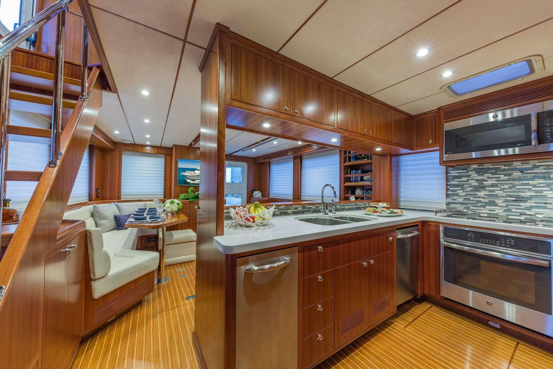 a kitchen with wooden cabinets aboard ASTURIAS Yacht for Charter