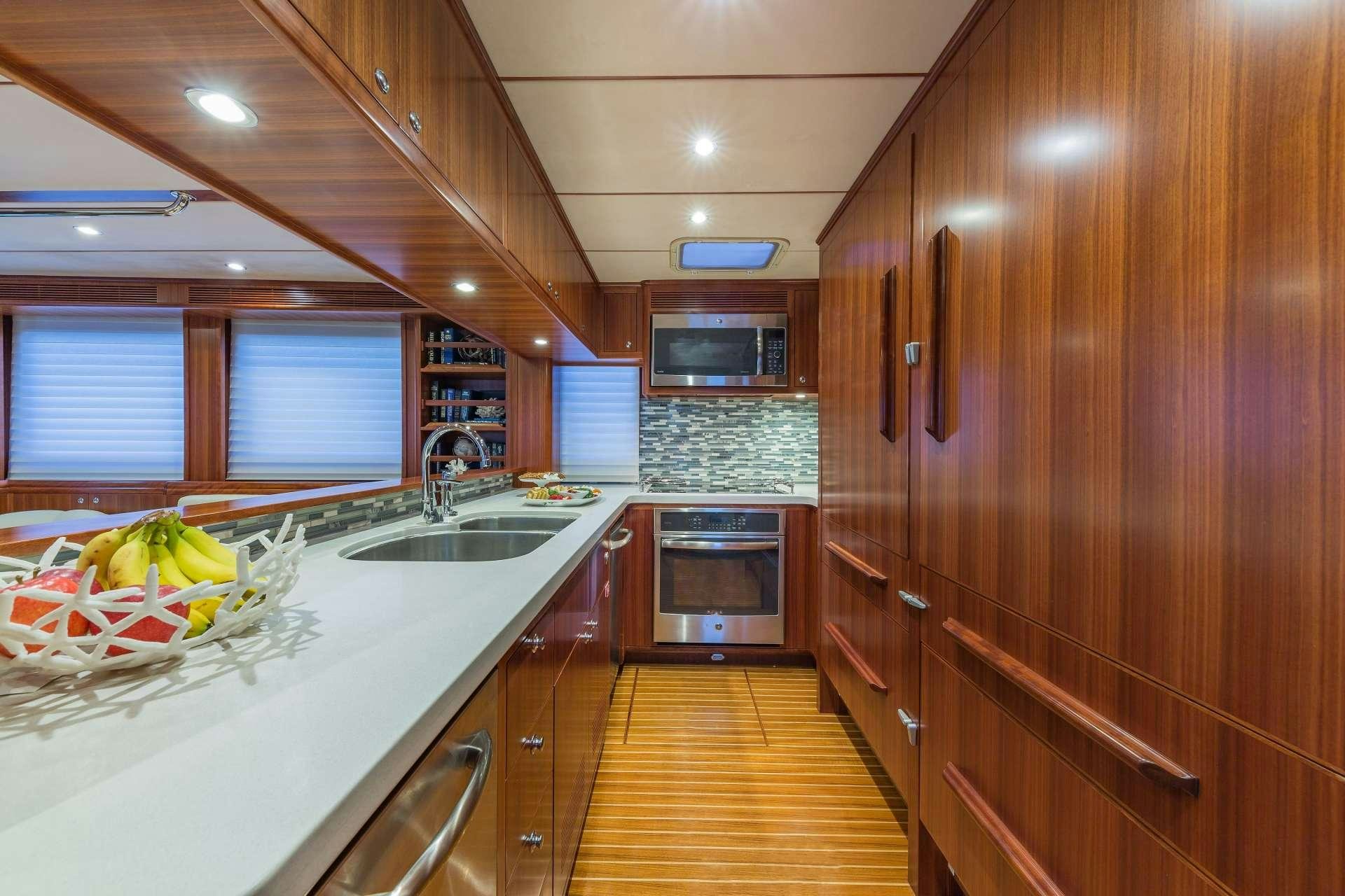 a kitchen with wooden cabinets aboard ASTURIAS Yacht for Charter