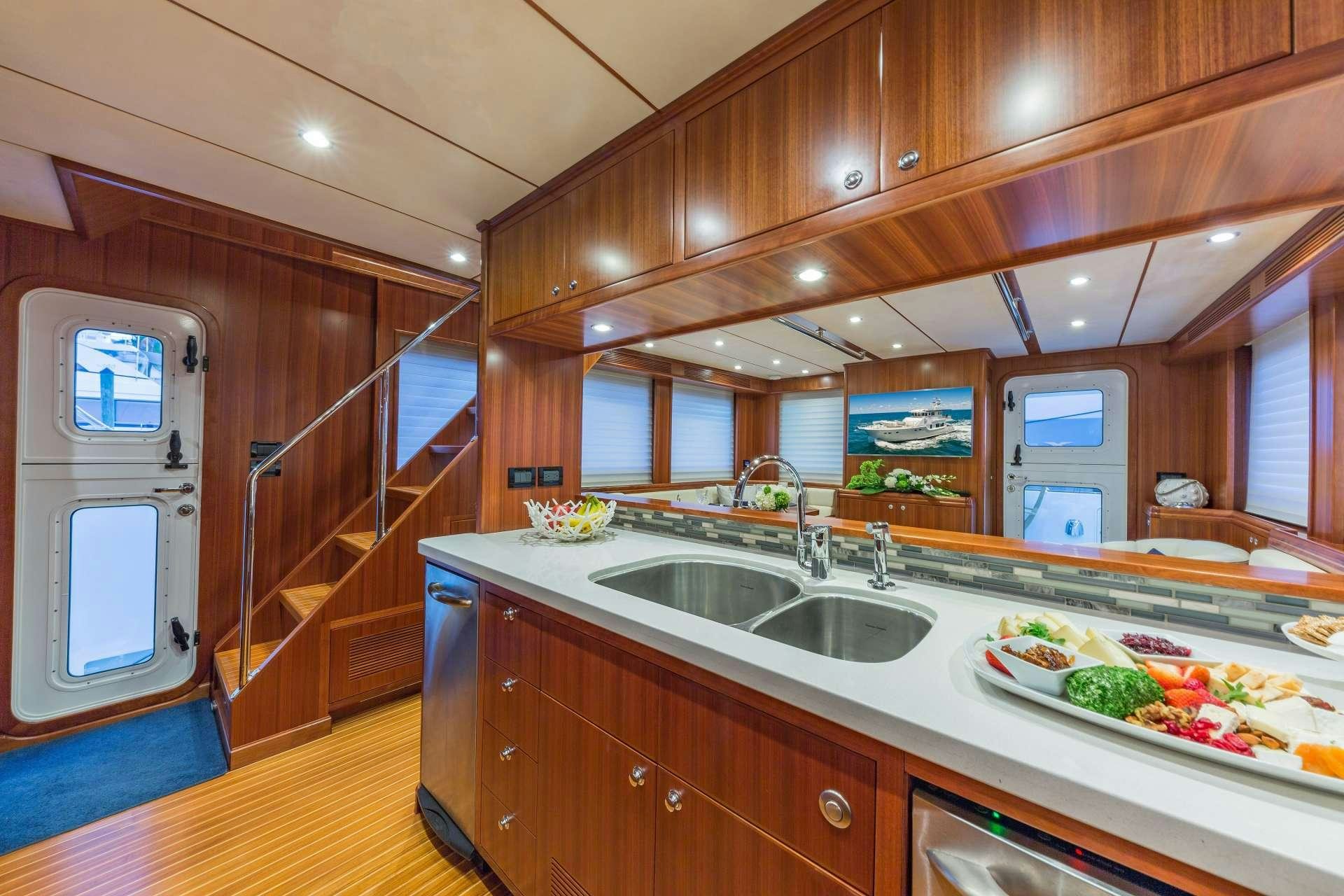 a kitchen with wooden cabinets aboard ASTURIAS Yacht for Charter