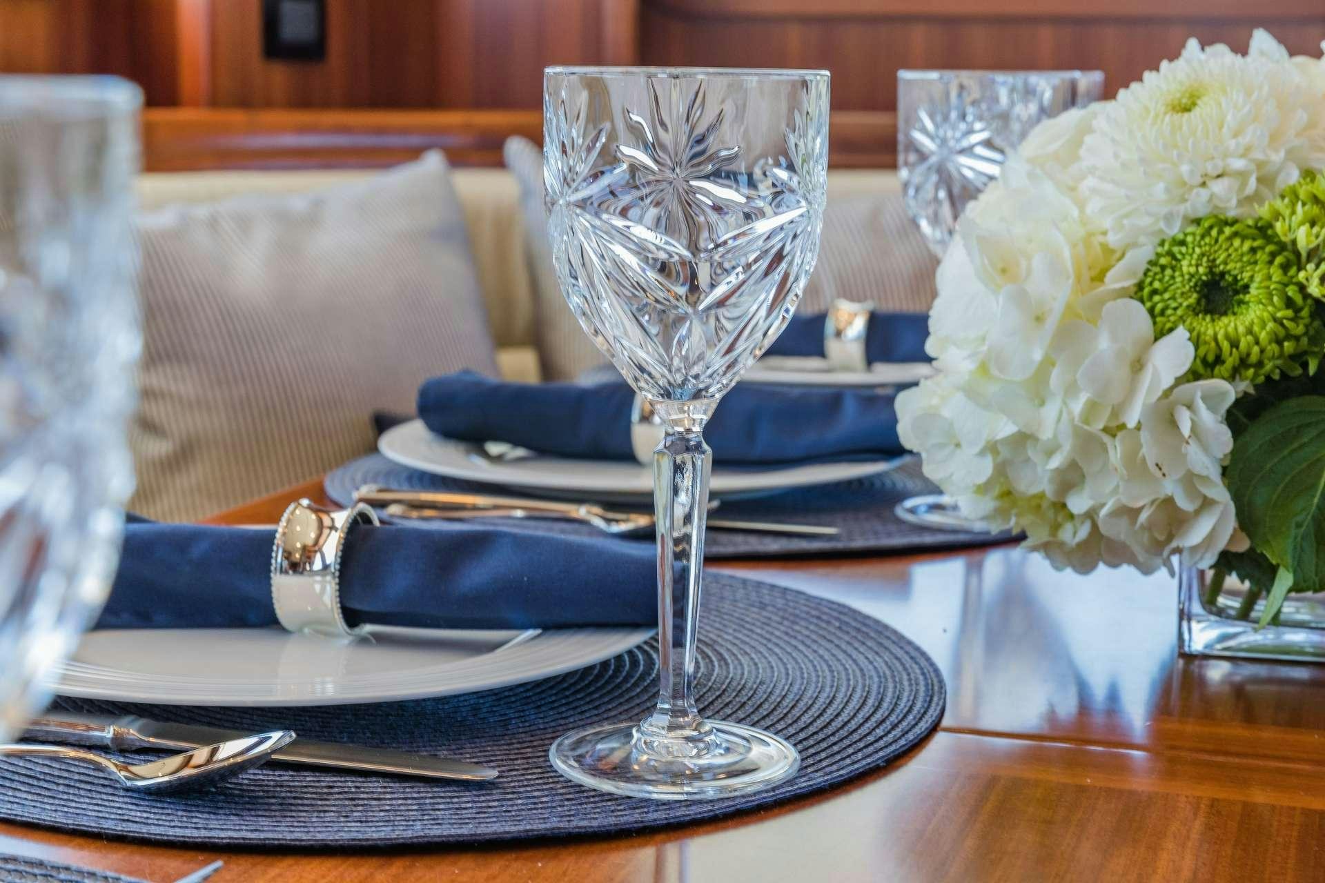 a glass of champagne on a table aboard ASTURIAS Yacht for Charter