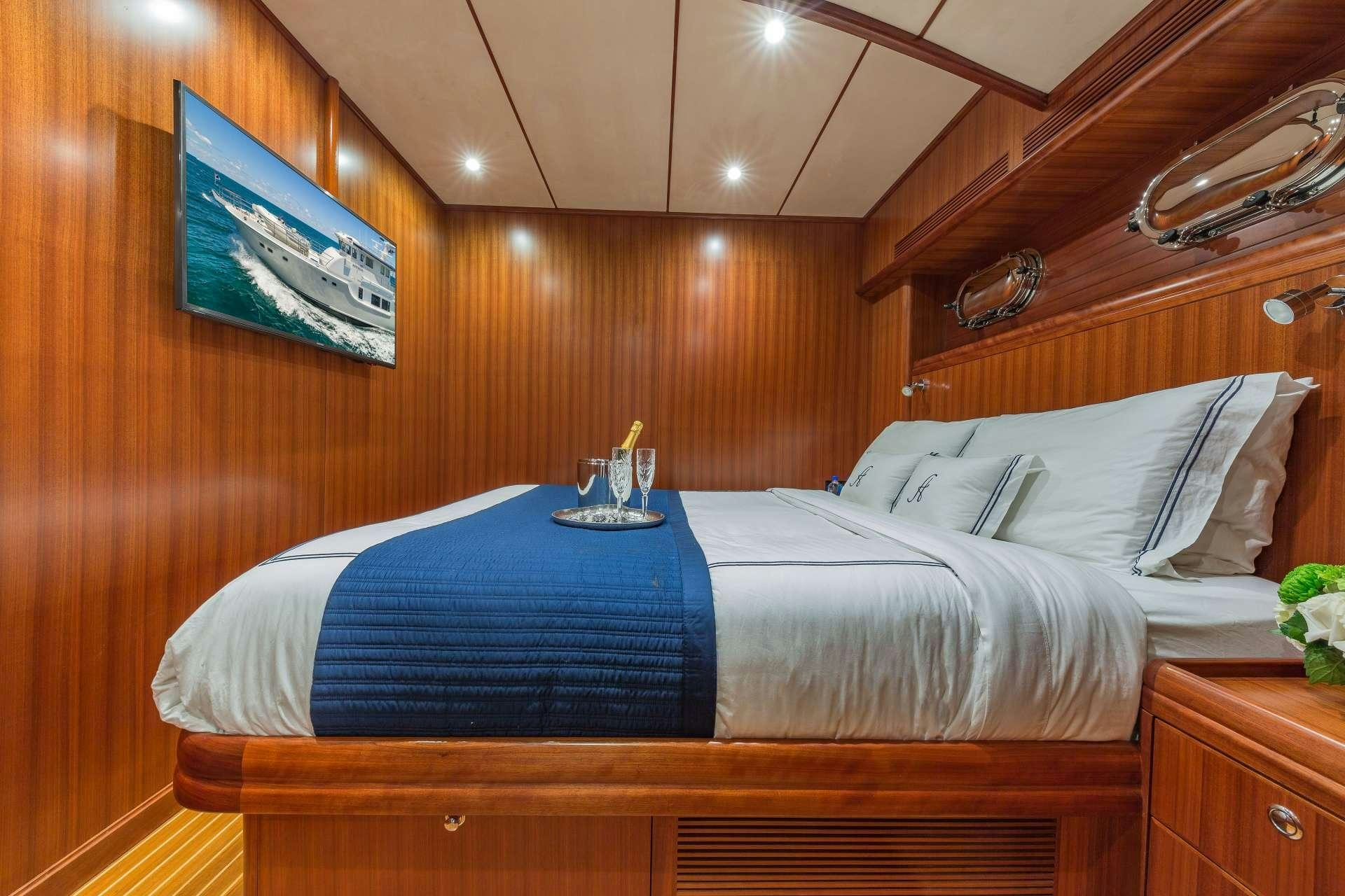a bed with a blue sheet aboard ASTURIAS Yacht for Charter