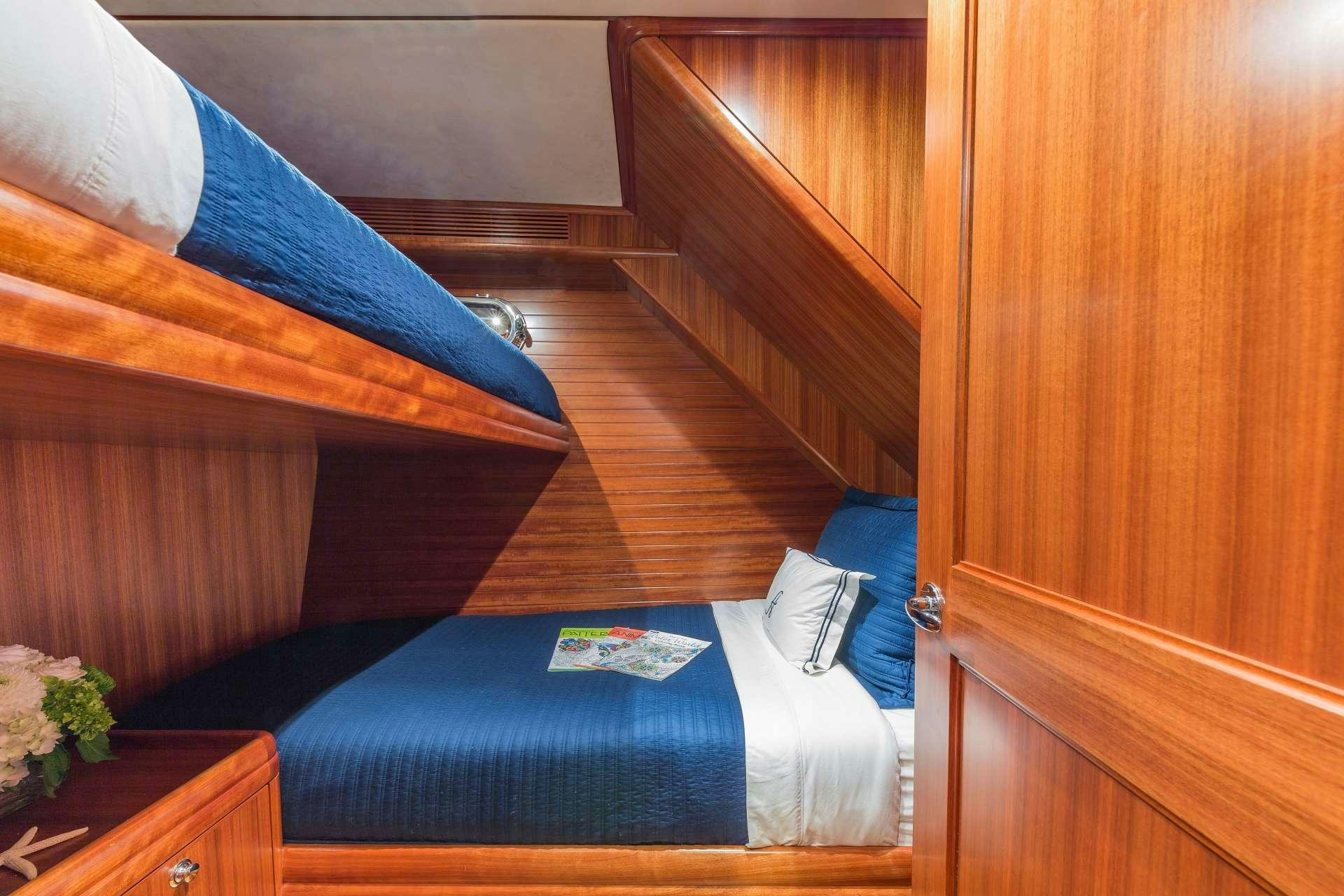 a bed with a blue sheet aboard ASTURIAS Yacht for Charter