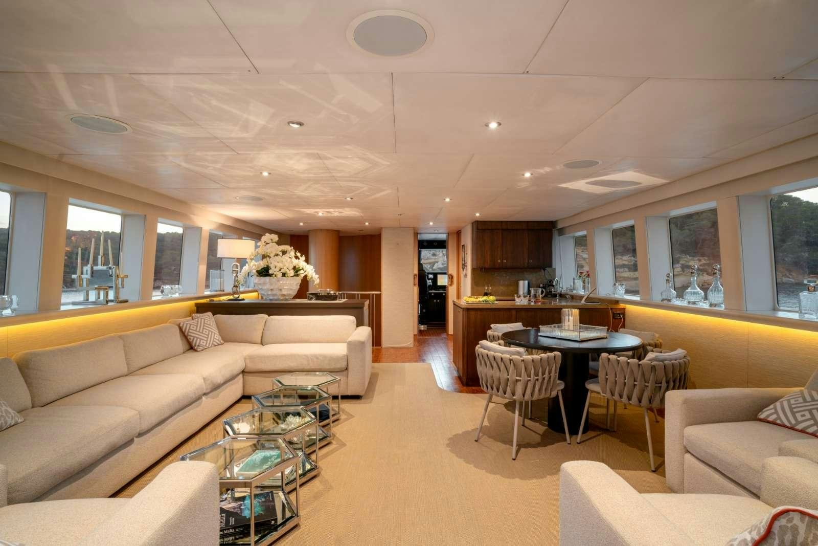 a living room with a couch and a table aboard ENVY Yacht for Charter