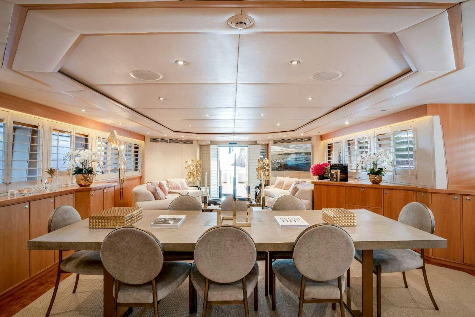 a large kitchen with a table and chairs aboard ENVY Yacht for Charter