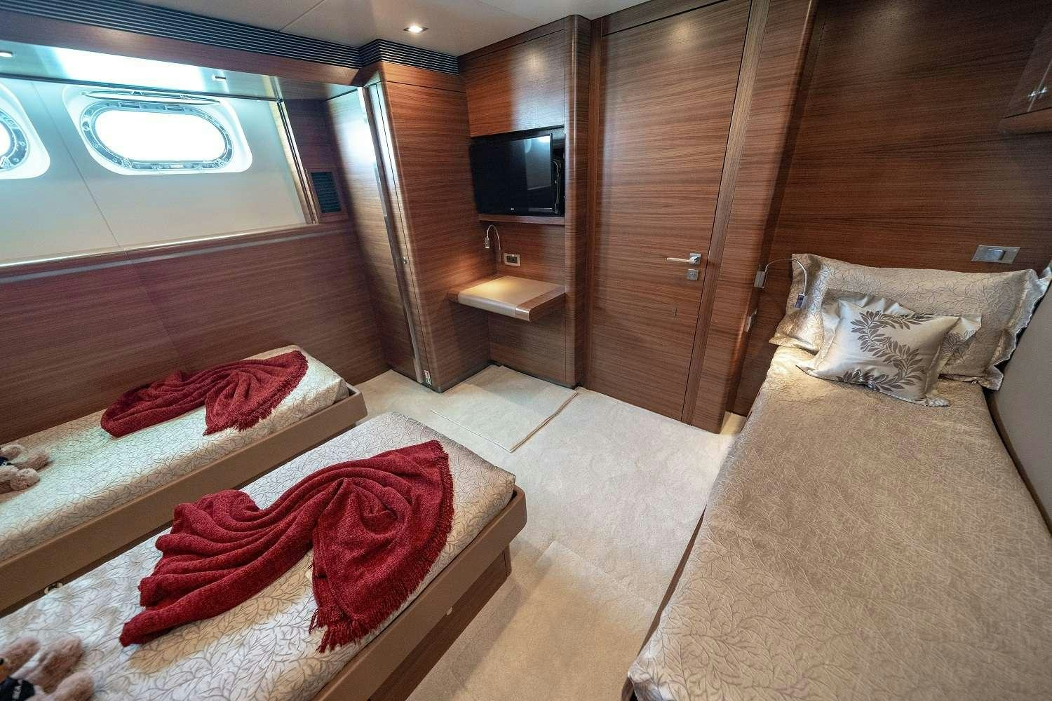 a room with a bed and a tv aboard SEA AXIS Yacht for Charter