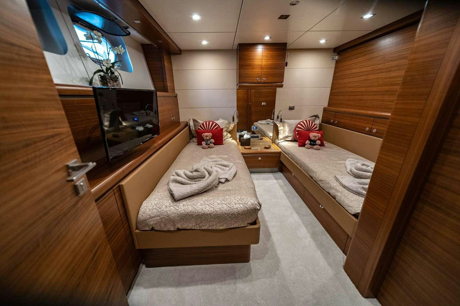 a room with a bed and tv aboard SEA AXIS Yacht for Charter
