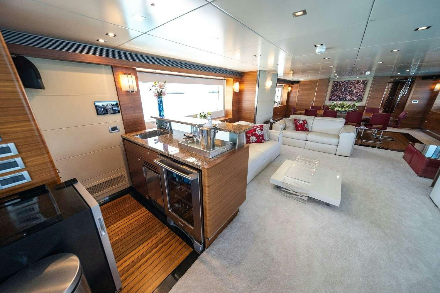 a living room with a large kitchen and a large island aboard SEA AXIS Yacht for Charter