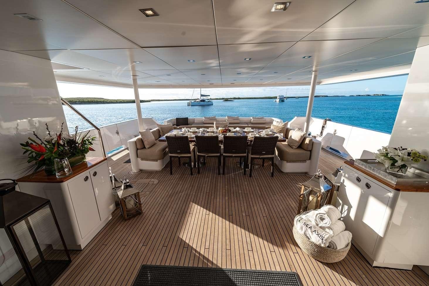 a room with a table chairs and a plant on the wall aboard SEA AXIS Yacht for Charter