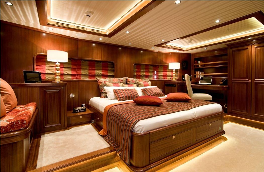 a bedroom with a bed and a desk aboard CLEAR EYES Yacht for Charter