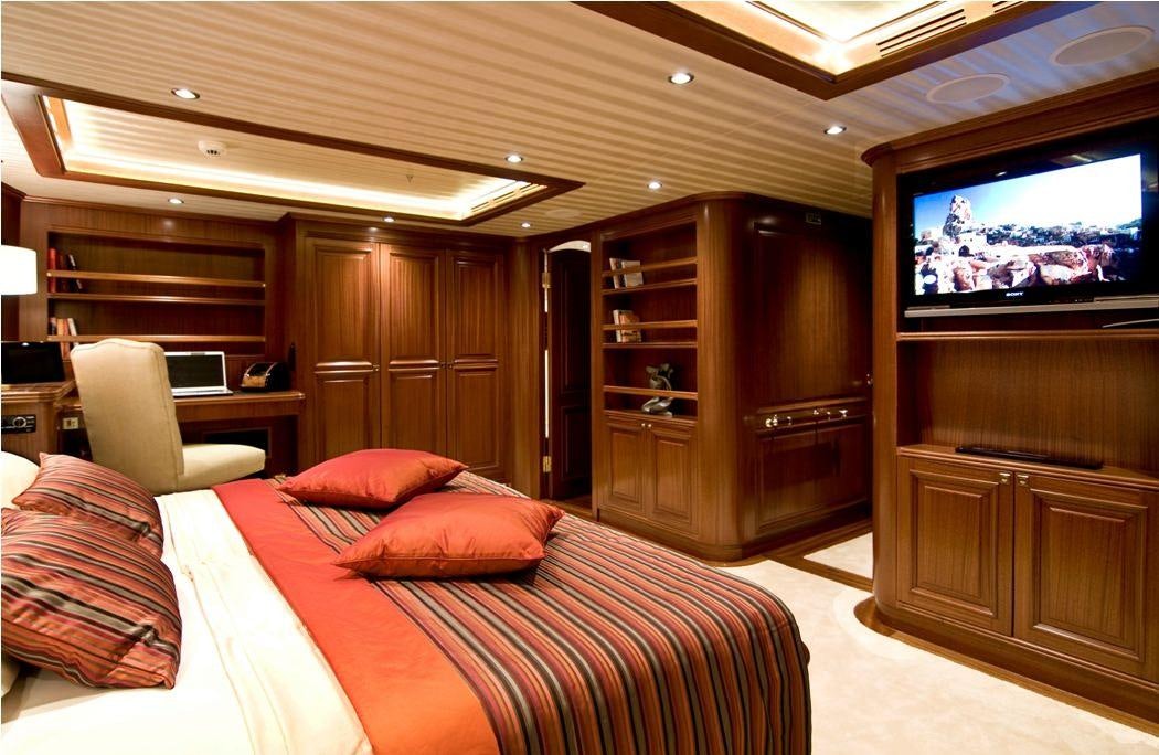 a hotel room with a bed and tv aboard CLEAR EYES Yacht for Charter