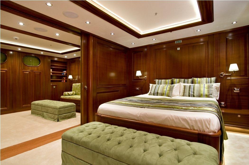 a room with a bed and a chair aboard CLEAR EYES Yacht for Charter