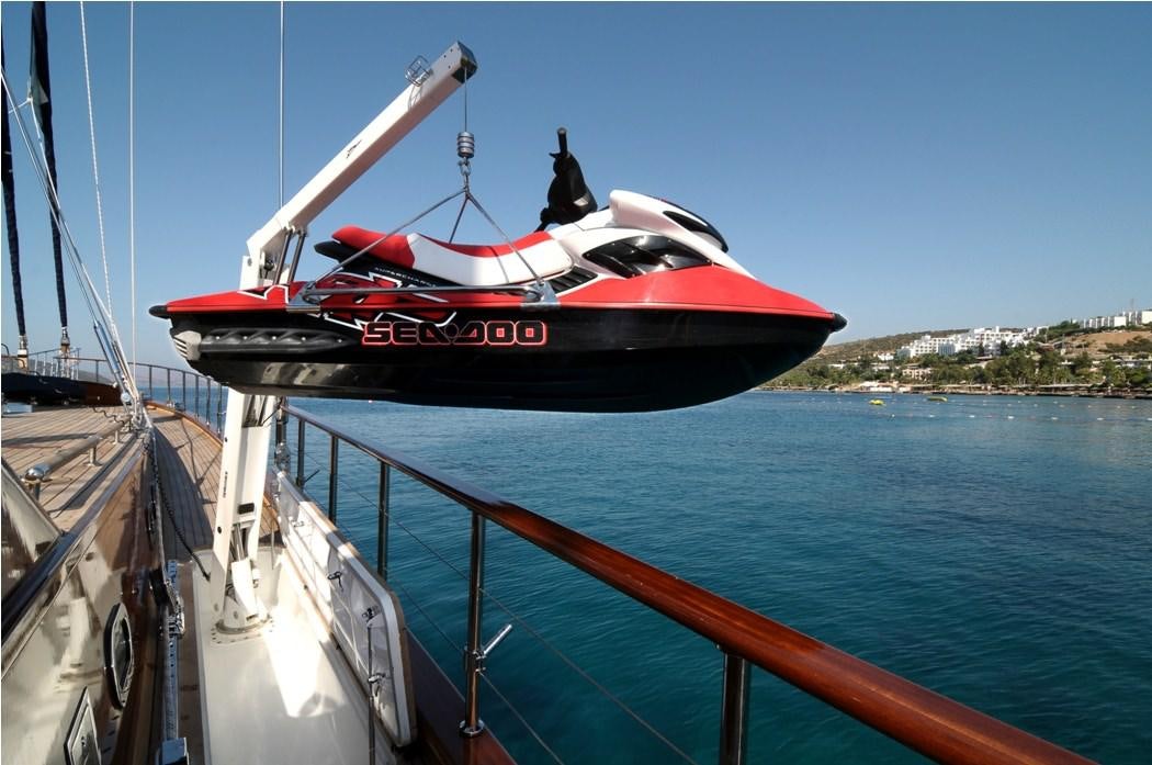 a red and black boat on a body of water aboard CLEAR EYES Yacht for Charter