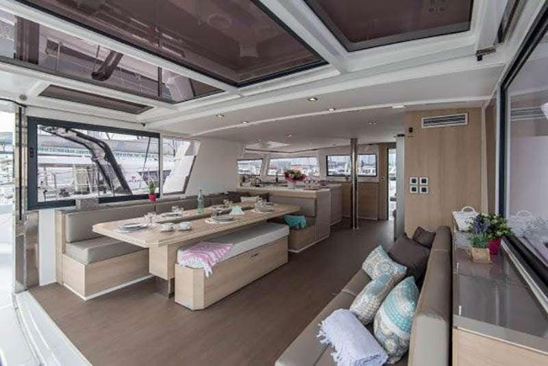 a living room with a large table aboard AD ASTRA Yacht for Charter