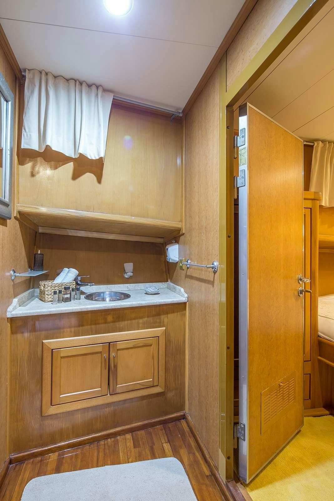 a bathroom with a sink and cabinets aboard morning star Yacht for Charter