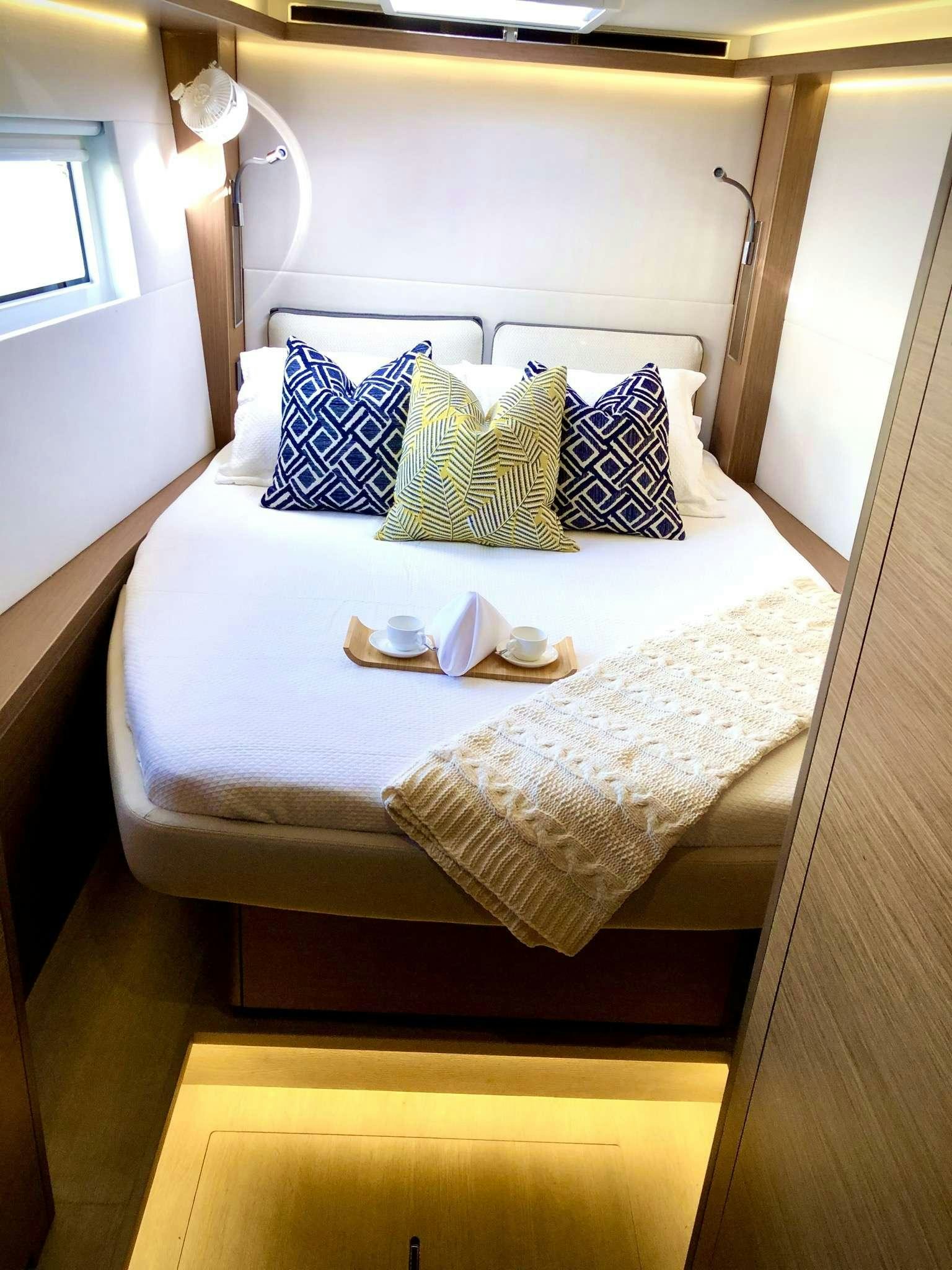 a bed with pillows and pillows aboard SEA IO Yacht for Charter